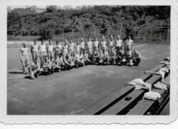 Group photo from Lloyd Olson scrapbook on the 344th Engineers, location unknown. Lloyd is thought to be in the front row, fourth from the left.